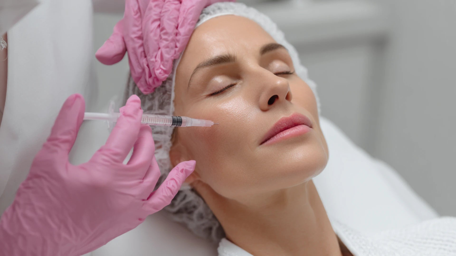 Clinician treating tired face using injectable and regenerative protocols.